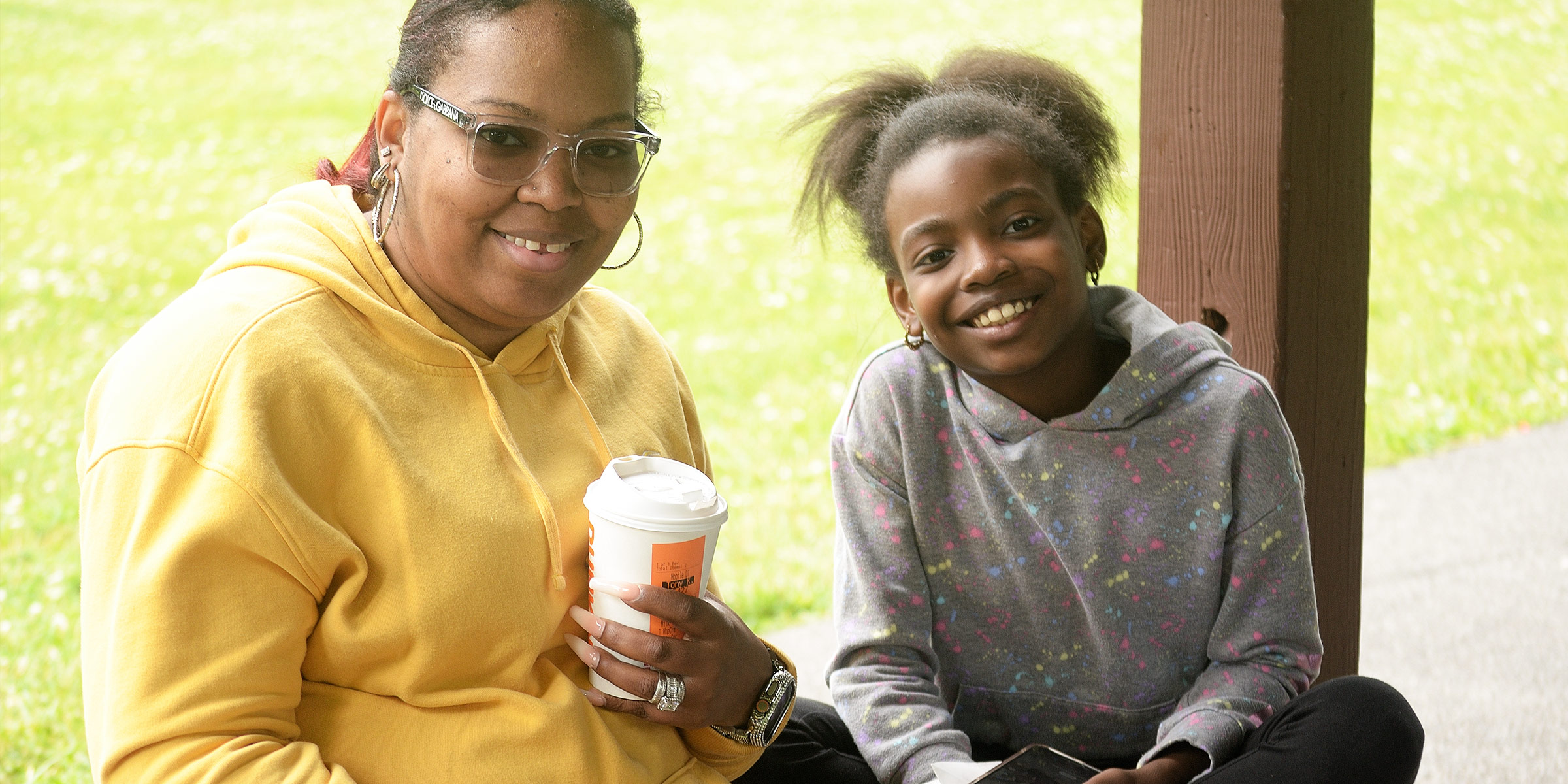 a mother sitting next to her daughter